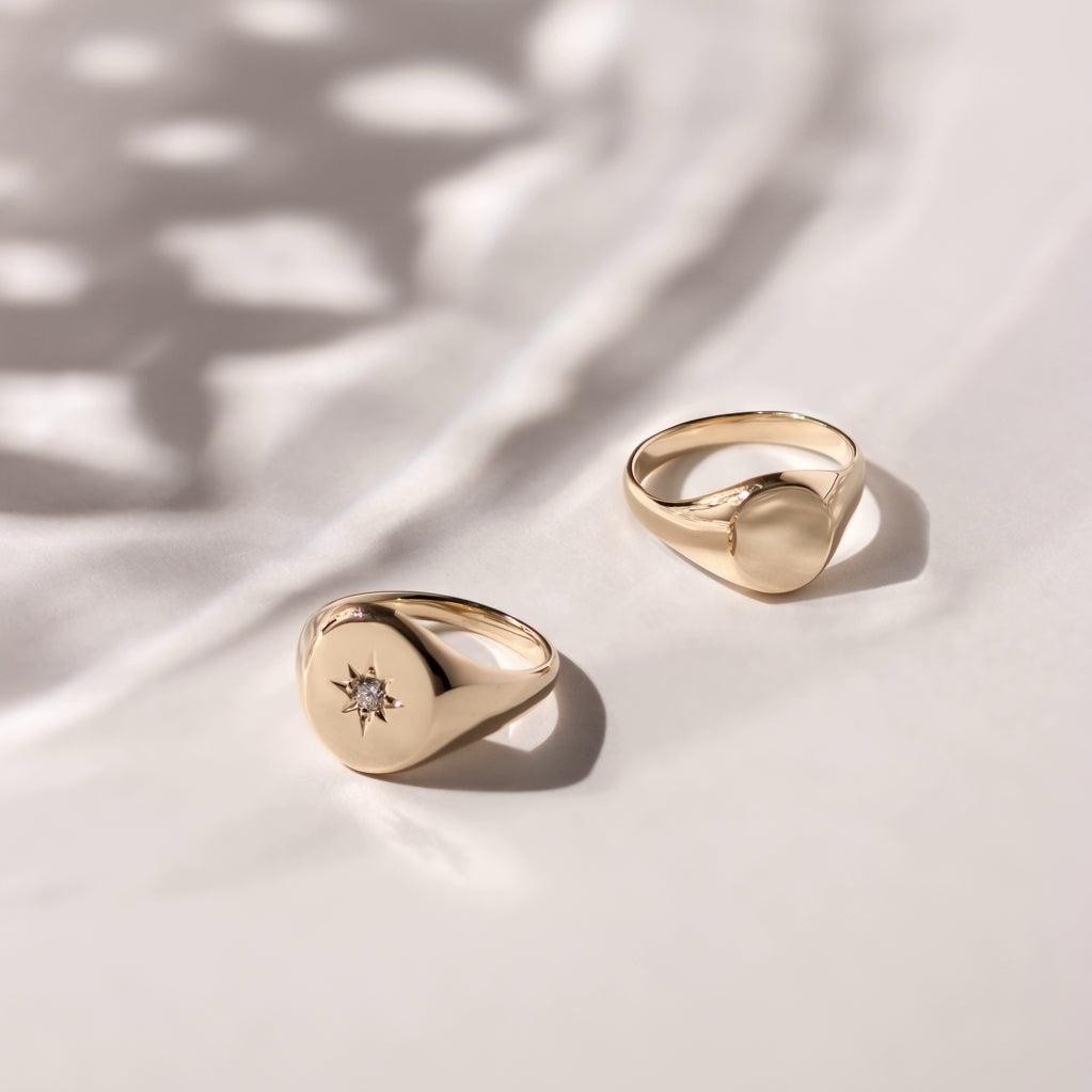 Two gold signet rings, one with a diamond star