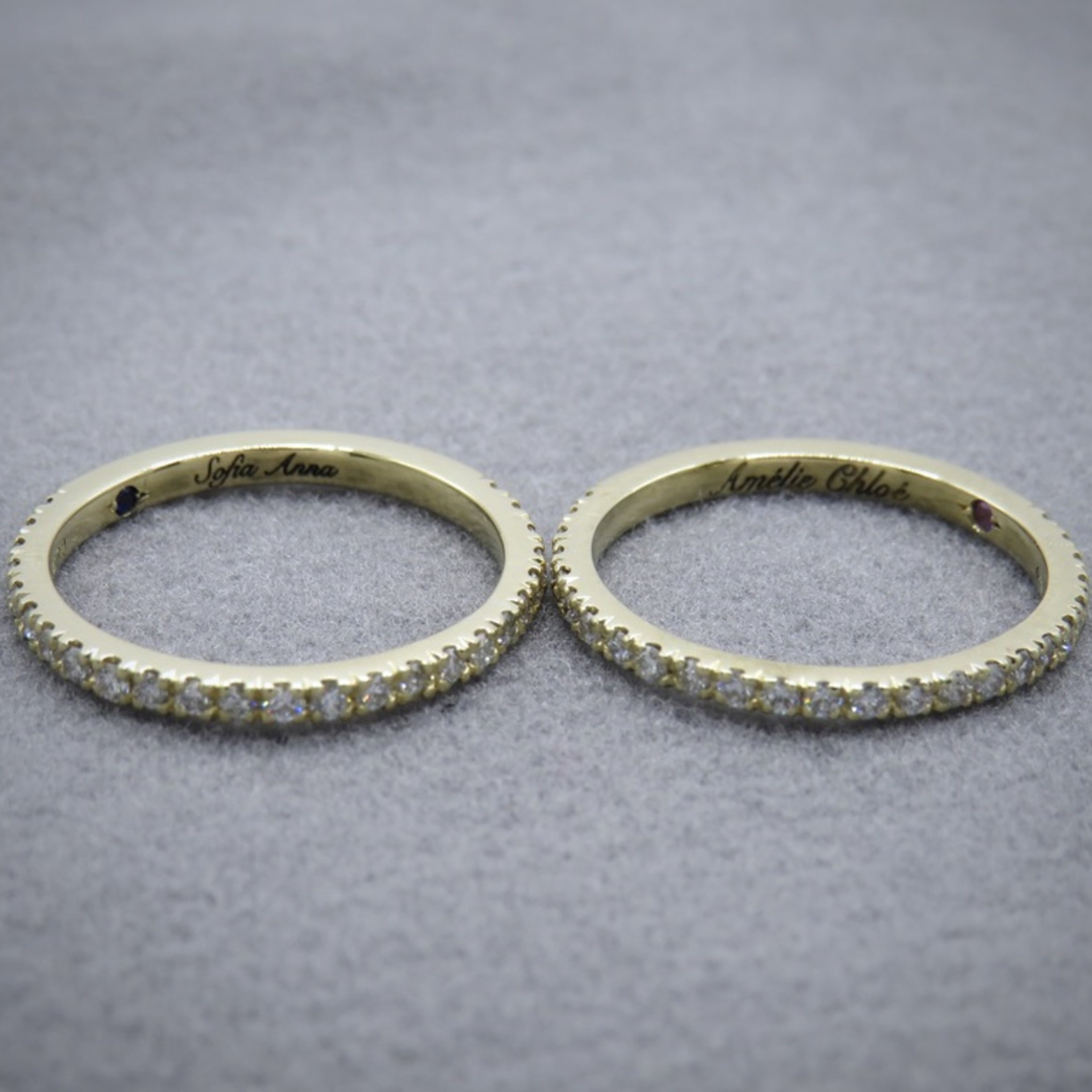 Two diamond and yellow gold half eternity rings with inlaid stones and engraving