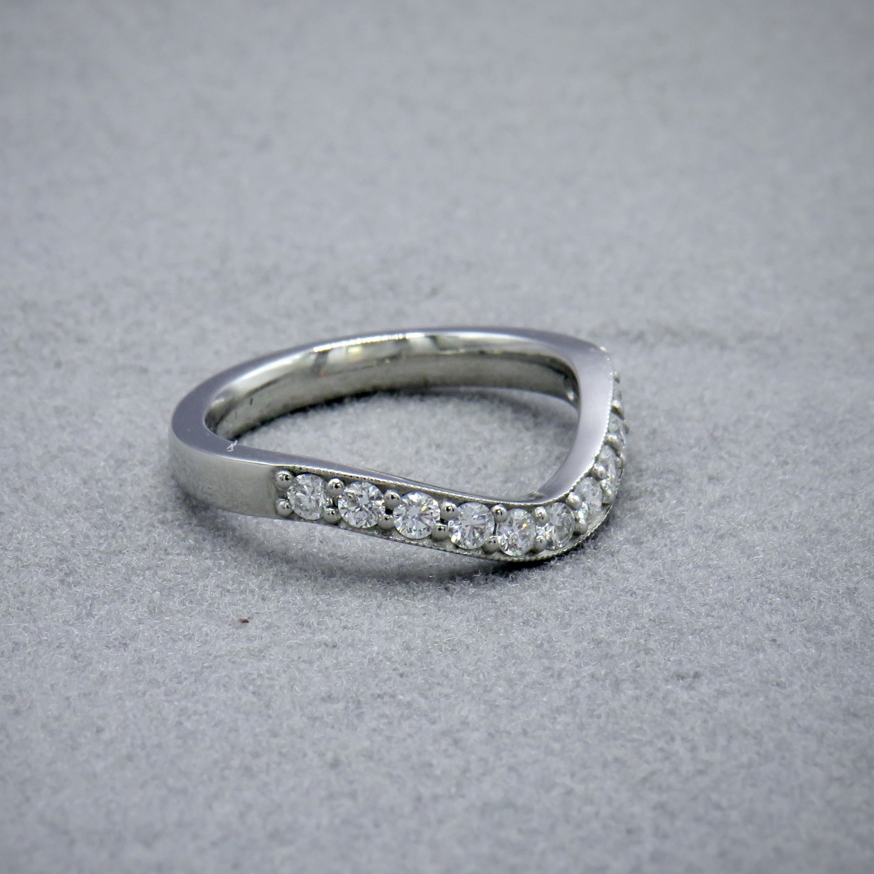 Curved white gold and diamond ring