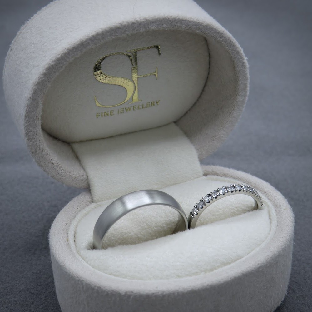 A jewellery box with two platinum wedding rings