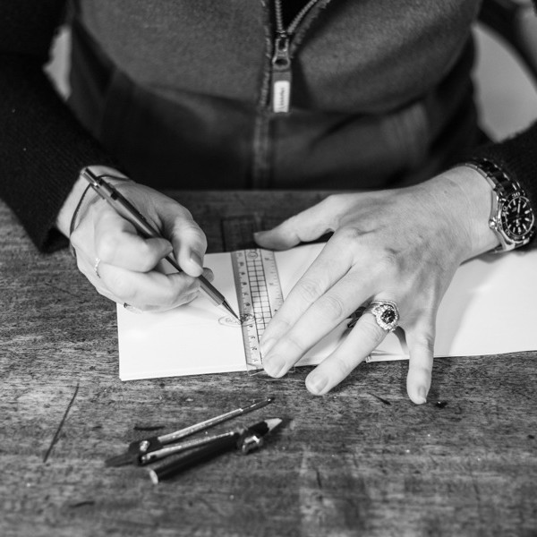 Black and white picture of woman's hands drawing